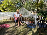 and sits with her in the calm of the garden